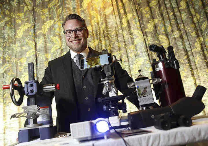 Rob Schorr is the inventor of the SyVu Universal Smartphone Adapter which allows users to attach a smartphone to microscopes, telescopes and binoculars so they can take photos and videos.  (Jonathan Quilter / The Columbus Dispatch)